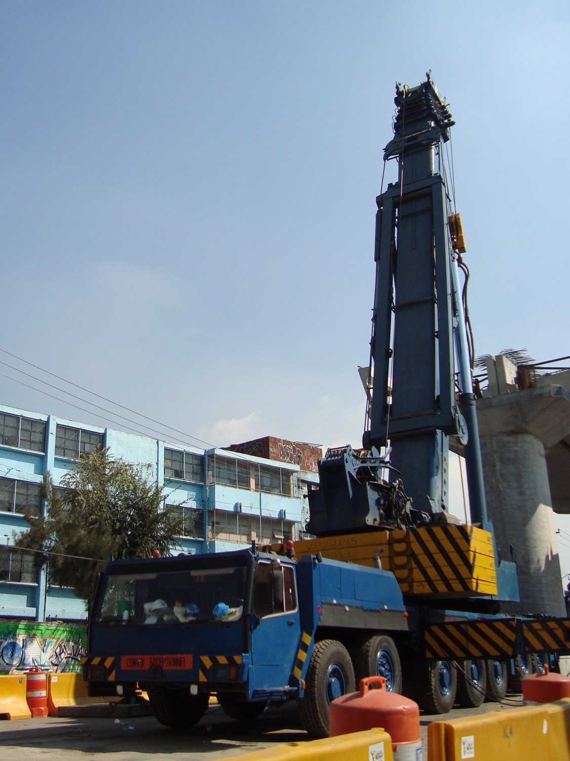 Grúa telescópica sobre camión en una obra del metro en Zapotitlán, Ciudad de México.